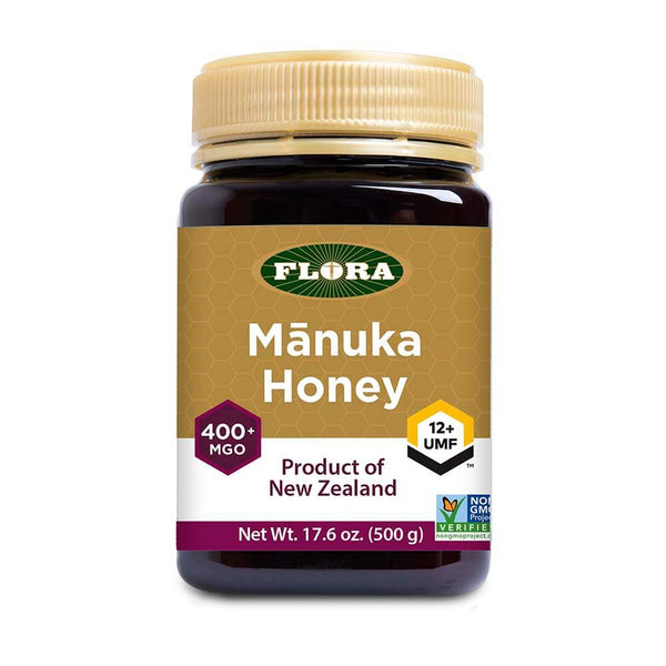 Jar of Flora Manuka Honey on a white background