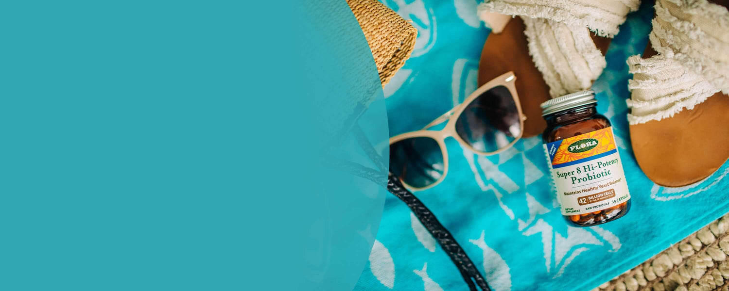 Vitamins on a beach setting with sunglasses and towel